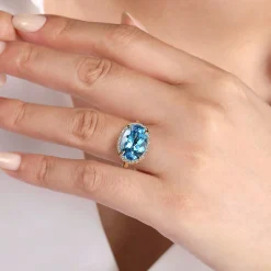 Gabriel & Co. 14K Yellow Gold Diamond and Oval Shape Blue Topaz Ladies Ring With Flower Pattern Gallery